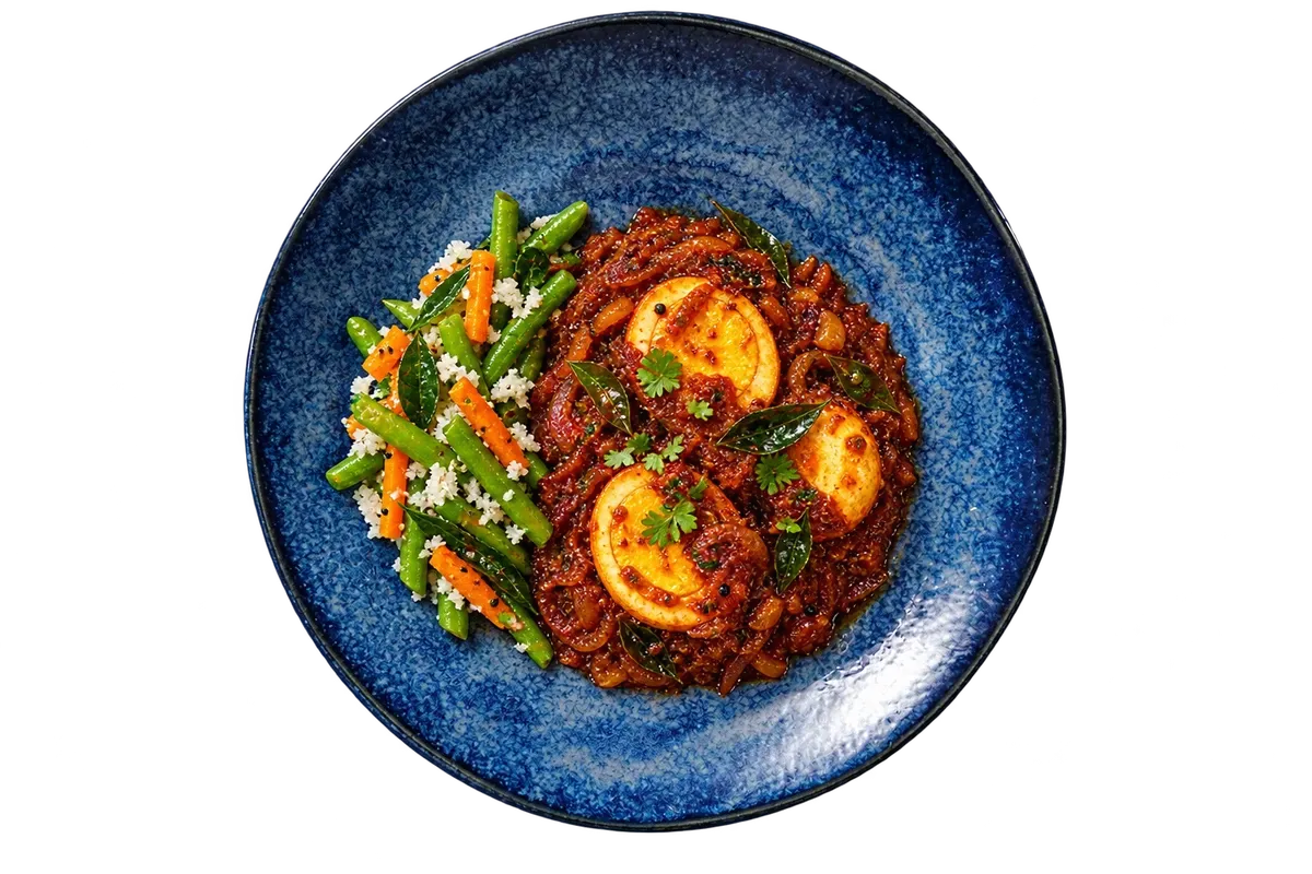 Kiryu dinnerware serving Kerala egg roast with a neat vegetable accompaniment.